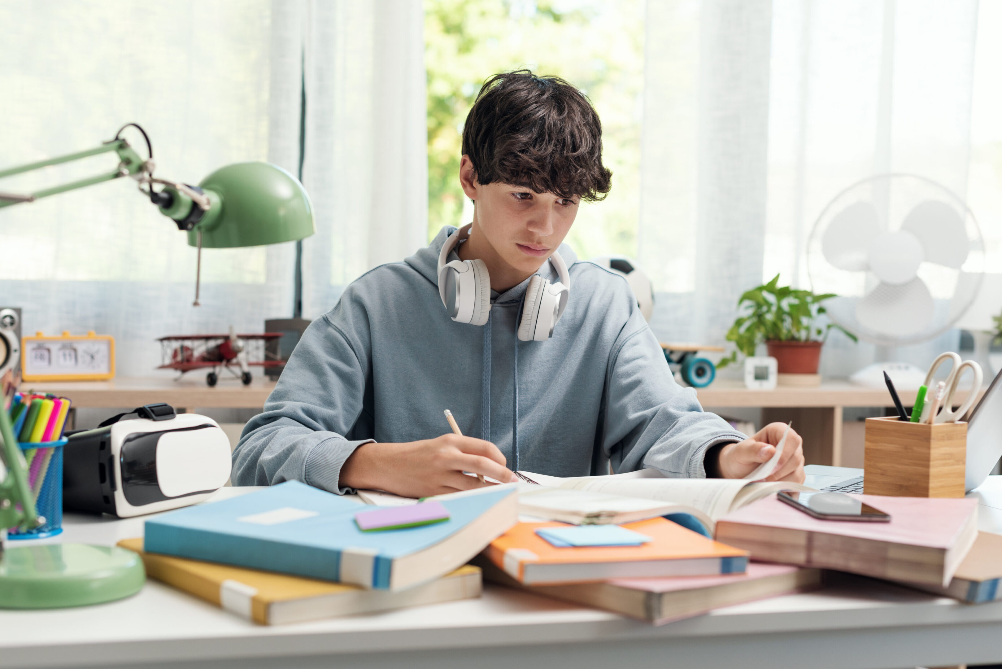Young person writing in study area