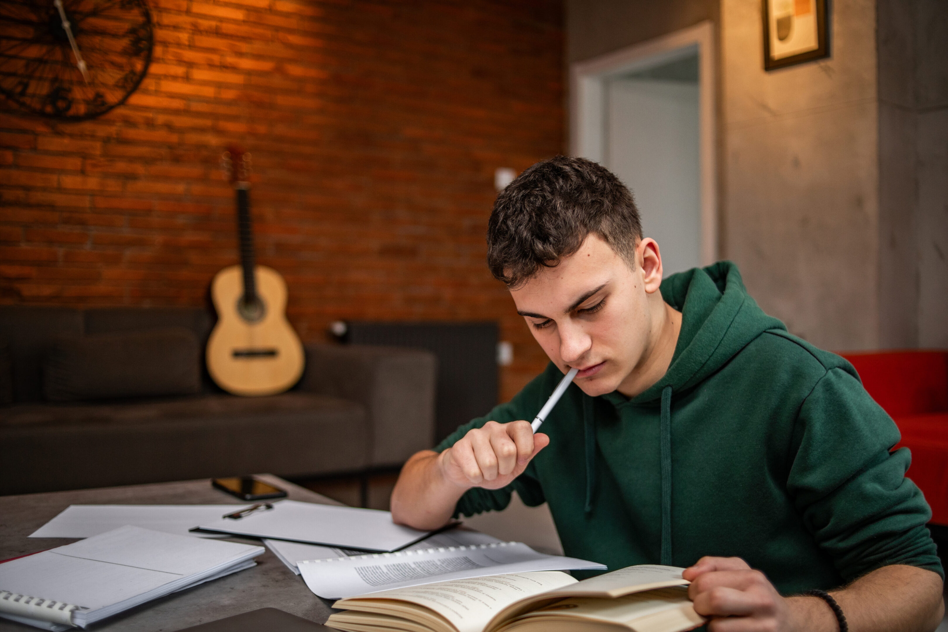 Teen studying with books and notes