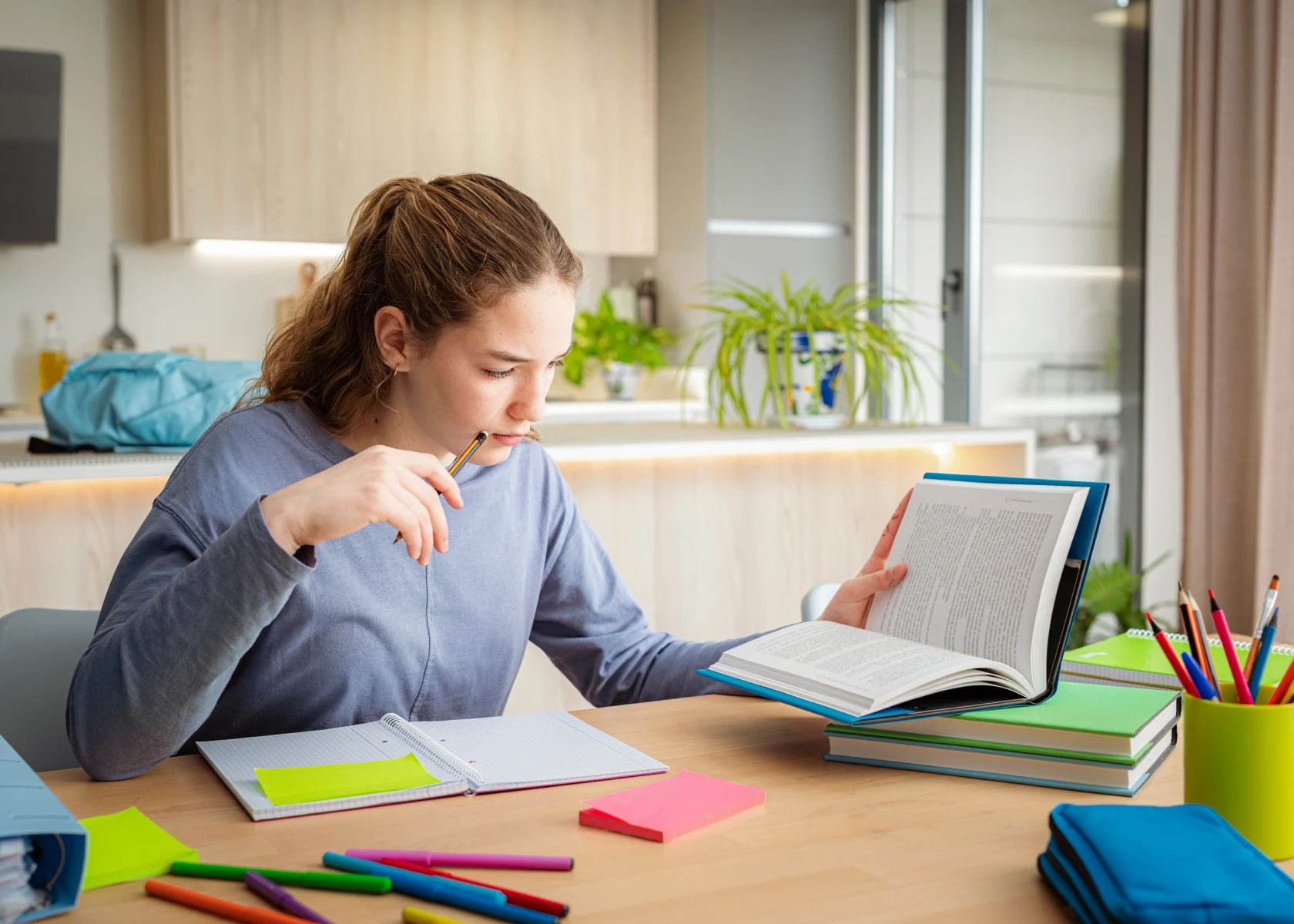 Young woman reading and taking notes