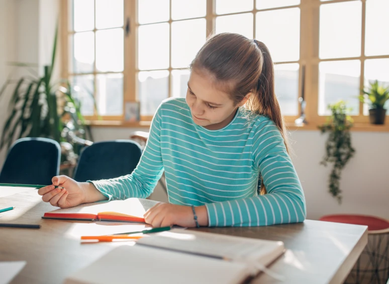 Girl writing at a desk