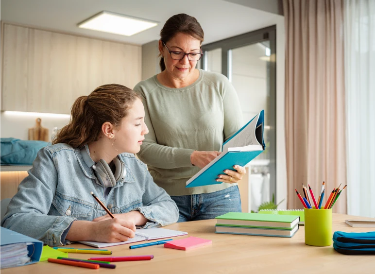 Woman helping girl with homework
